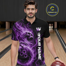 Load image into Gallery viewer, Male model wearing a black bowling polo shirt in a bowling alley featuring a skull clutching a bowling ball surrounded by swirling purple energy flames