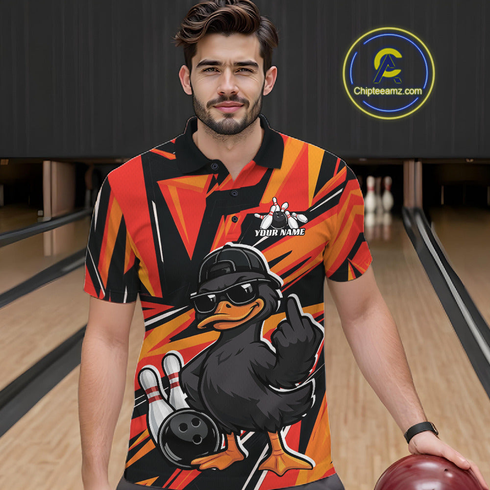 Male model wearing a black and orange bowling polo in a bowling lane with duck-themed graphics and geometric background elements.