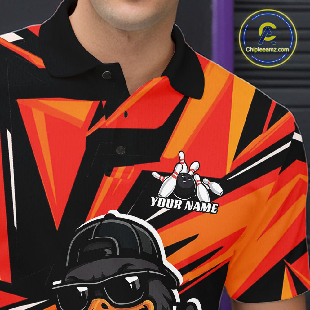 Close-up of the left chest on a black and orange bowling polo featuring duck, bowling ball, and pin artwork.