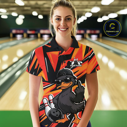 Female model wearing a black and orange bowling polo in a bowling lane with duck-themed graphics and geometric background accents.