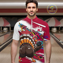 Load image into Gallery viewer, Front view of a male model wearing a red custom quarter zip bowling shirt with a funny graffiti turkey holding a bowling ball, paint splatter accents in a bowling alley.