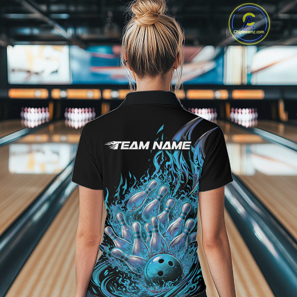 Back view of female model in bowling lane wearing black and blue quarter zip featuring flaming bowling ball striking pins with blazing fire action graphics.