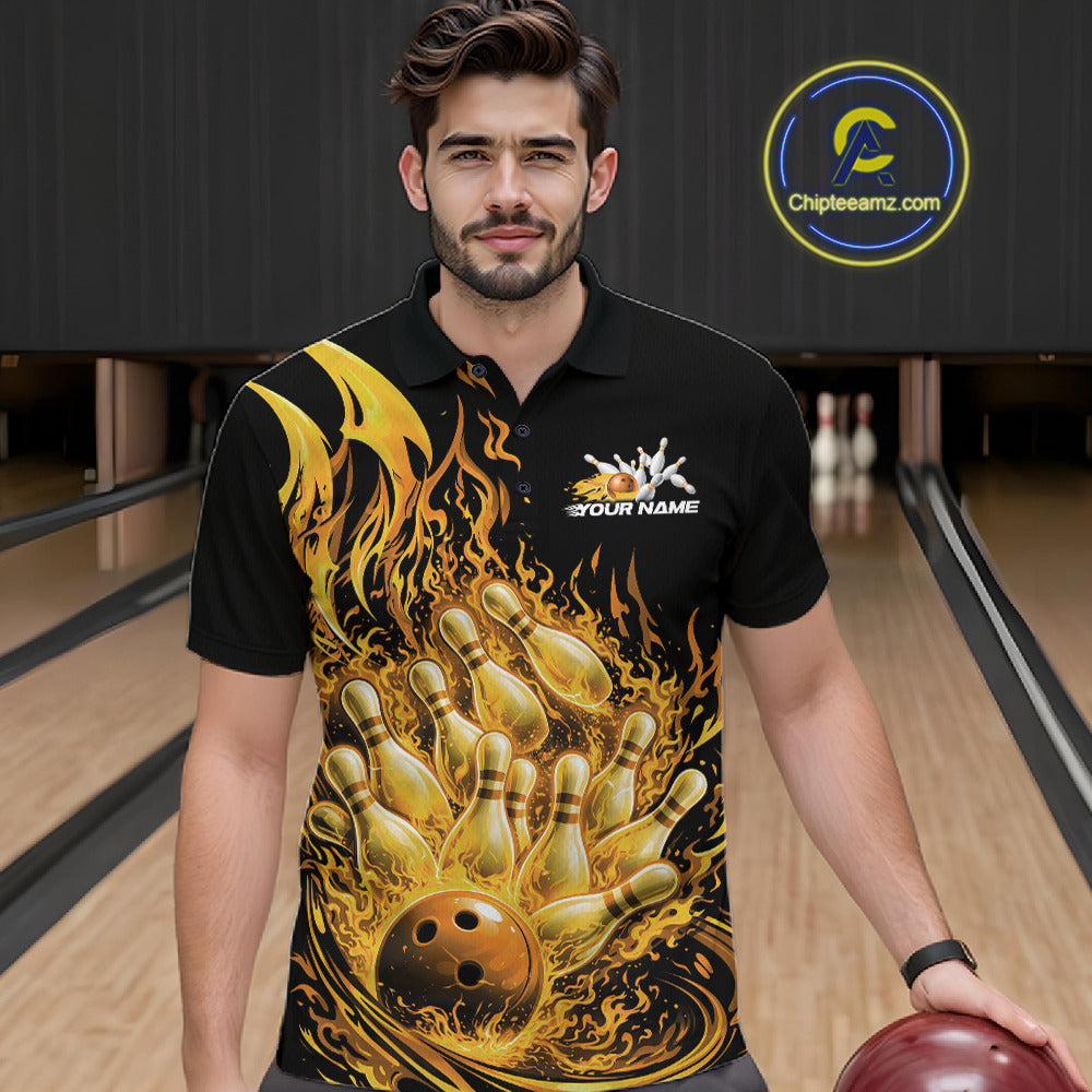Front view of a male model at the bowling lane wearing a black and yellow polo with blazing bowling strike graphics.