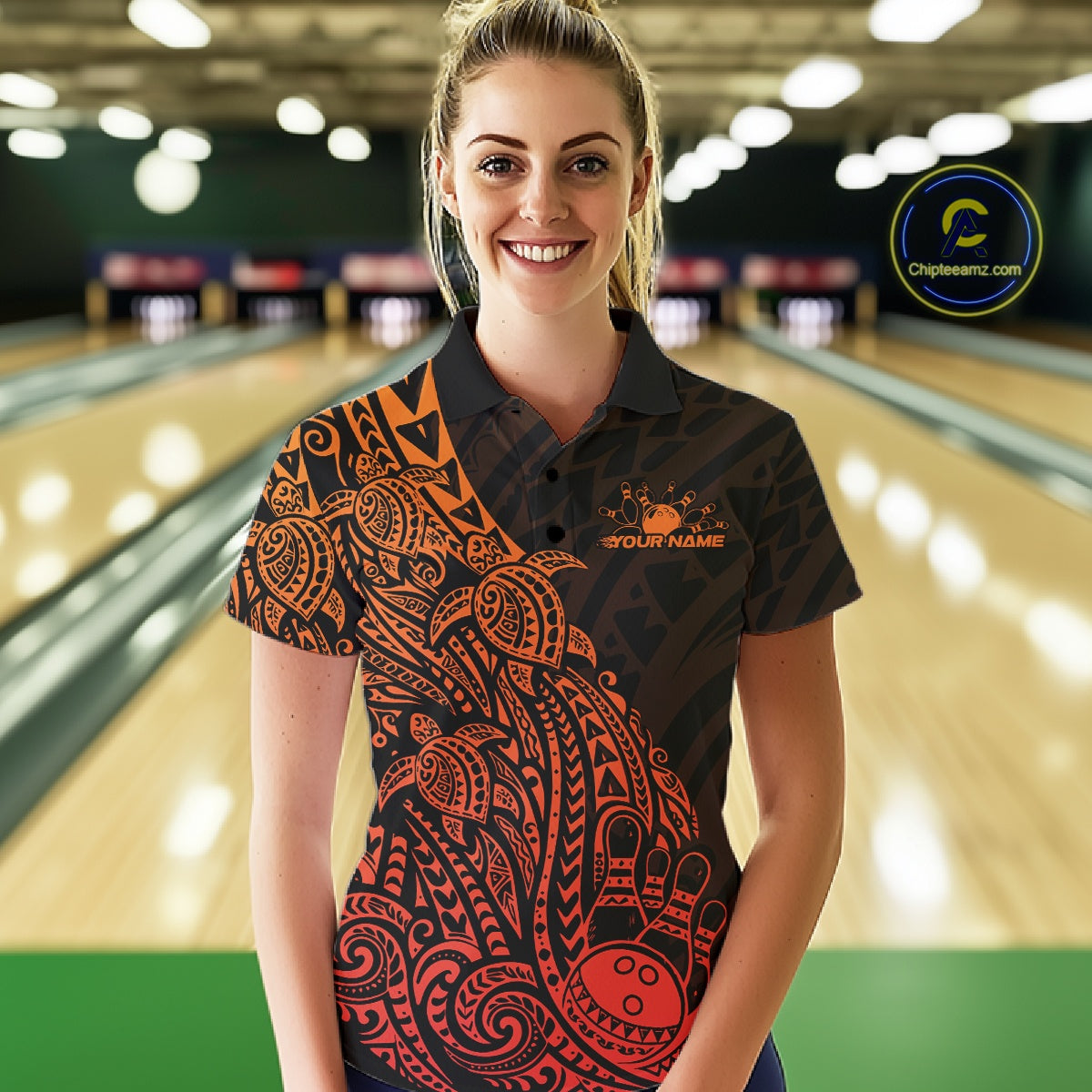 Female model wearing a black and red orange bowling polo shirt at the lane with turtle-inspired bowling graphics.
