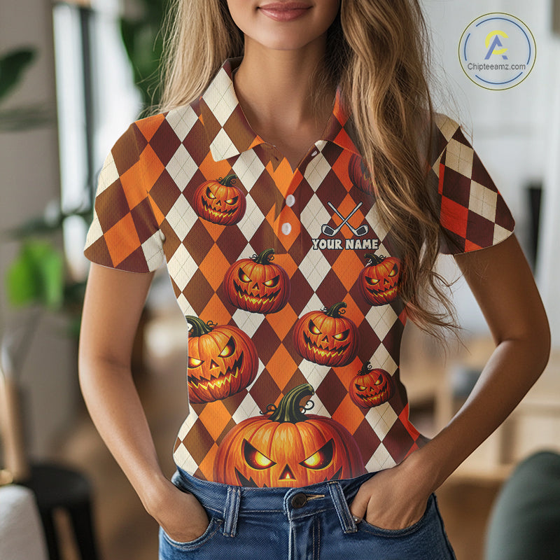 A woman wearing a short-sleeve polo shirt with a Halloween-themed harlequin pattern featuring orange, brown, and cream diamonds and jack-o'-lanterns. The shirt has a custom name print on the chest that reads 'YOUR NAME'.