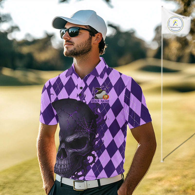 A man wearing a purple and lavender argyle patterned polo shirt with a large black skull graphic on the front, standing on a golf course. He is also wearing a white cap, sunglasses, and a white belt.