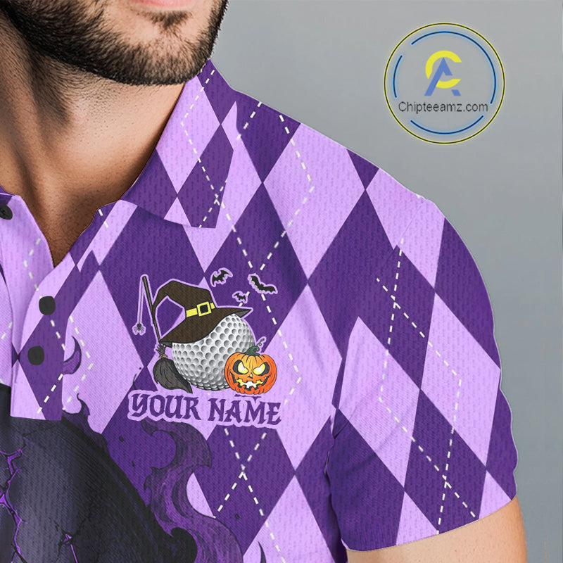 A close-up of a man wearing a purple and lavender argyle short-sleeve polo shirt with a custom graphic on the chest. The graphic features a golf ball with a witch's hat and a pumpkin, with the text 'YOUR NAME' below it.