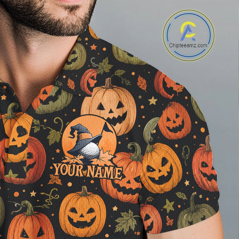 A close-up of a man wearing a black short-sleeve shirt with an all-over Halloween print of orange and green pumpkins, leaves, and stars. The center of the shirt features a customizable graphic with a golf ball, a witch's hat, autumn leaves, and the text 'YOUR NAME'.