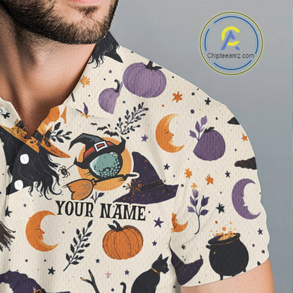 A close-up of a man wearing a short-sleeve collared shirt with a Halloween-themed print featuring pumpkins, moons, stars, cauldrons, and a witch riding a broomstick. The shirt has a cream base with a multicolor graphic print and the text 'YOUR NAME' on the front.