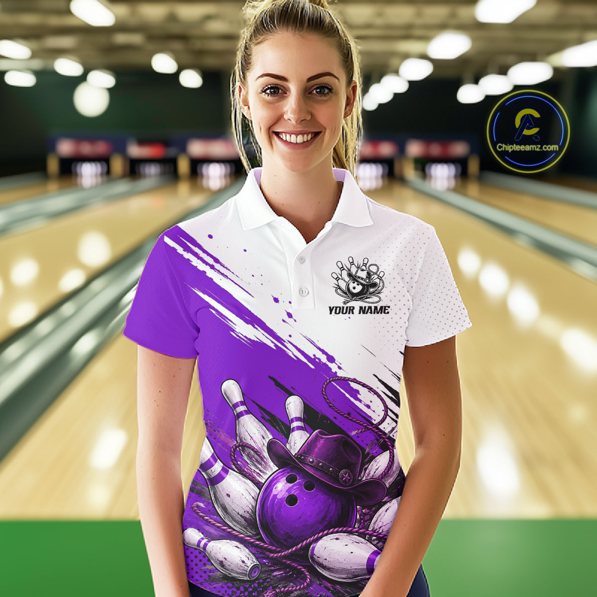 A woman stands in a bowling alley wearing a custom short-sleeve polo shirt with a purple and white bowling graphic design. The shirt features a white upper chest and collar, a purple and white brushstroke pattern across the front, a bowling pin illustration, and a customizable name patch.