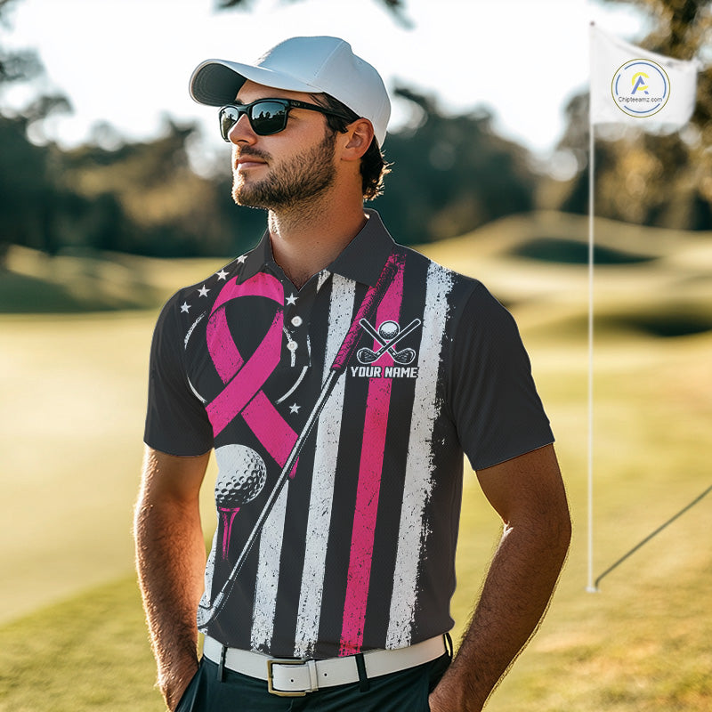 A man wearing a custom black and pink striped polo shirt with a breast cancer ribbon design, sunglasses, and a white cap, standing on a golf course.