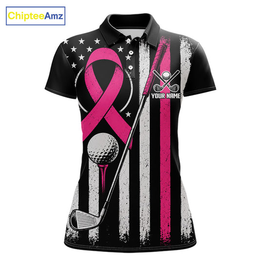A women's short-sleeve polo shirt with a black base and a distressed American flag pattern in black, white, and pink. The design features a large pink breast cancer awareness ribbon, a golf ball and club, and a golf flag with the text 'YOUR NAME'.