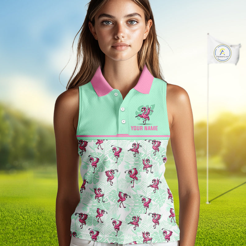 A woman modeling a sleeveless polo shirt with a mint green and pink design featuring flamingo prints, set against a blurred golf course background with a flagstick visible.
