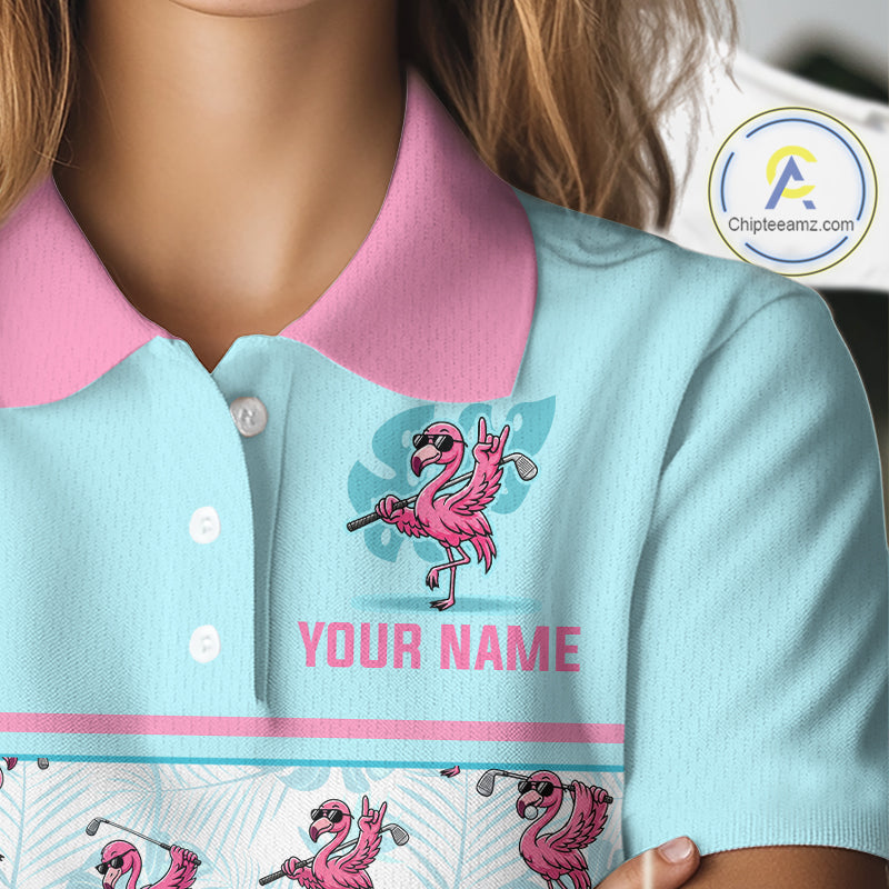 A close-up of a light blue polo shirt with a pink collar, featuring a cartoon flamingo graphic and the text 'YOUR NAME' on the front. A brand watermark for 'Chipteeamz.