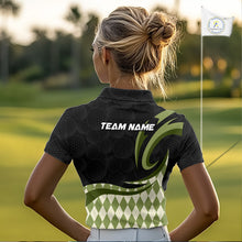 Load image into Gallery viewer, Woman wearing a black and green patterned polo shirt with a blurred indoor background