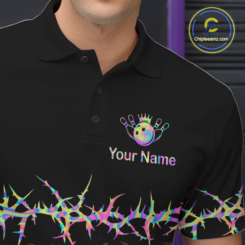 A close-up of a black polo shirt worn by a model, featuring a colorful bowling-themed graphic with a crown, pins, and the text 'Your Name' on the left chest, plus a matching thorny pattern along the hem. A circular 'Chipteeamz.