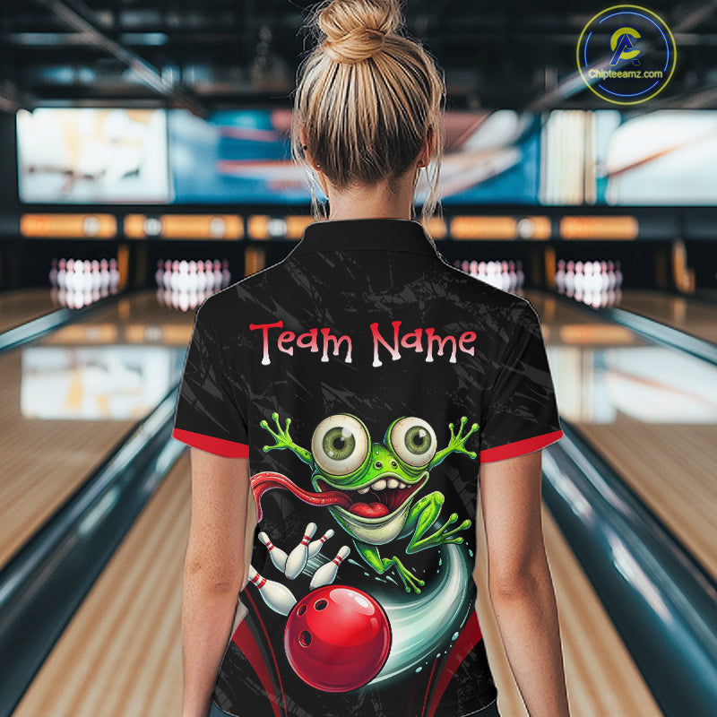 A woman viewed from behind wearing a black bowling shirt with a colorful cartoon frog graphic and the words 'Team Name' on the back, standing in a bowling alley.