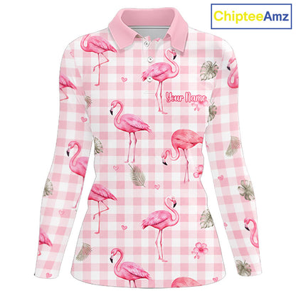 A long-sleeve women's polo shirt with a pink and white gingham pattern, decorated with pink flamingos, palm leaves, and small hearts. The shirt features a pink collar and a customizable text placeholder 'Your Name' printed on the chest.