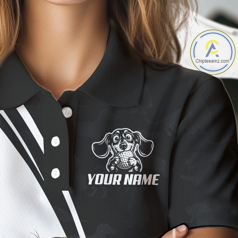 Close-up of a person wearing a black polo shirt with a white printed dachshund graphic and the text 'YOUR NAME' on the chest. The image includes a circular 'Chipteeamz.
