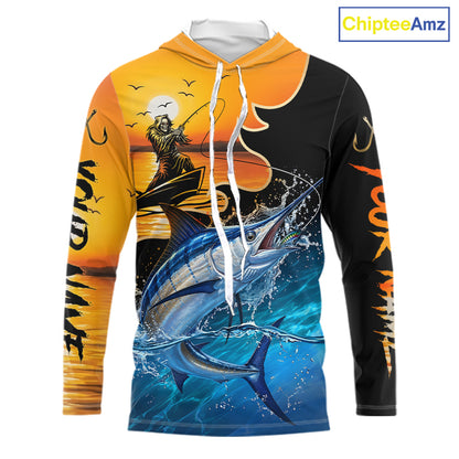 Long sleeve hooded fishing shirt with a fish reaper and marlin design on a sunset background