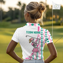 Load image into Gallery viewer, Person wearing a white polo shirt with a skeleton golfer design on a golf course