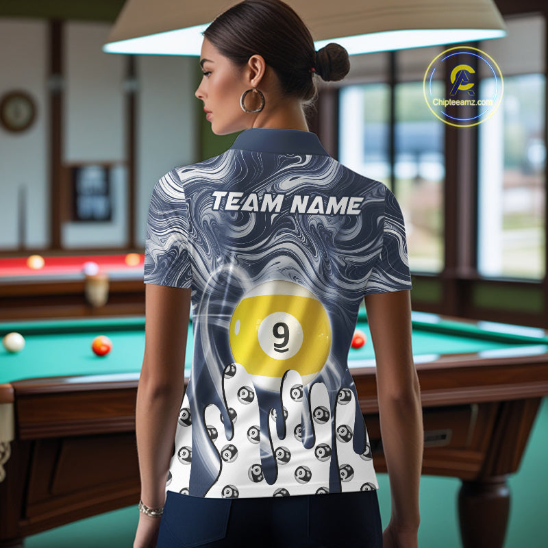 Back view of woman wearing a blue marble swirl 8 ball and 9 ball pool shirt in a billiards hall.