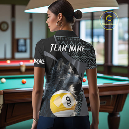 Man wearing a shirt with a wolf and pool ball design, standing in a bar.