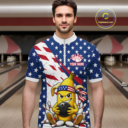 Man wearing a patriotic-themed quarter zip shirt with a banana cartoon character holding a bowling ball in a bowling alley.