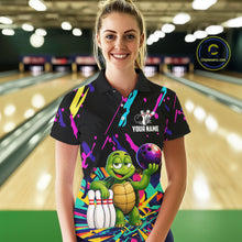 Load image into Gallery viewer, Woman wearing a colorful bowling-themed shirt with a turtle graphic in a bowling alley.