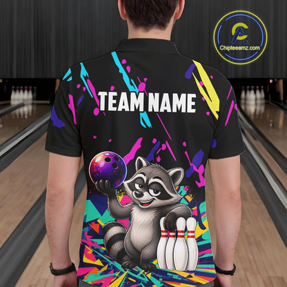Person wearing a black bowling shirt with colorful design and raccoon graphic in a bowling alley.