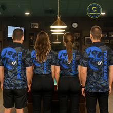Load image into Gallery viewer, Back view of pool players wearing custom blue skull billiard shirts in a game room.
